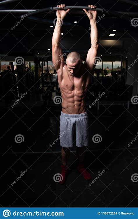 Handsome Muscular Man Flexing Muscles In Gym Stock Photo Image Of