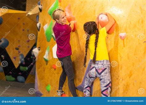 Instructors Helping Children Climb Wall In Gym Stock Image Image Of