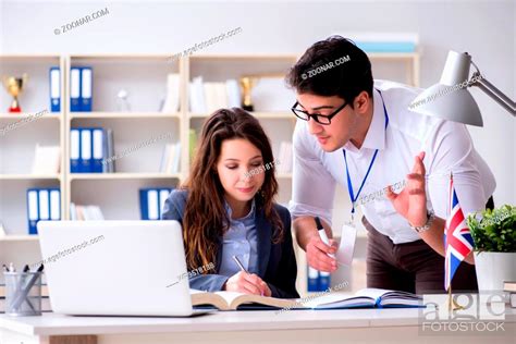 Teacher Explaining To Student At Language Training Stock Photo