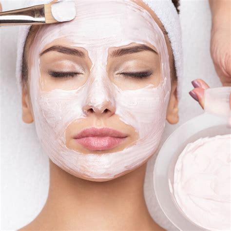 Woman Receiving Facial Mask In Spa Beauty Salon
