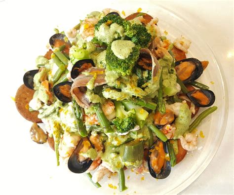 Cappon magro, is an elaborate genoese salad of seafood and vegetables over hardtack arranged into a decorative pyramid and dressed with a rich sauce. cappon magro, una ricetta ligure senza glutine e latricini