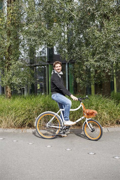 Portrait Of Smiling Man With Bicycle On A Lane Stock Photo