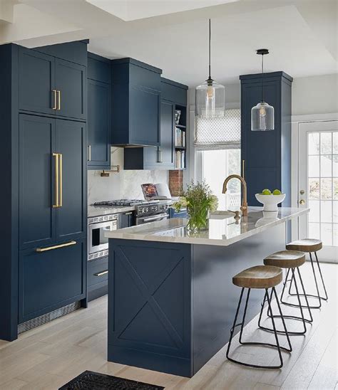 Brass and gold hardware provide a modern yet traditional look. Blue Kitchen with Brass Hardware - Transitional - Kitchen