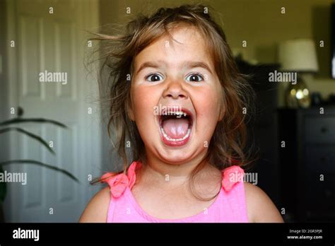 Portrait Of Cute Girl Screaming At Home Stock Photo Alamy