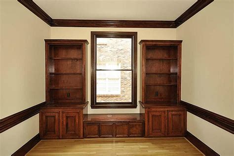 Situated in a living room, study or master bedroom, the bookcase is an important component of the home's overall style and architectural detail. Home office with stained trim and built in bookcases ...