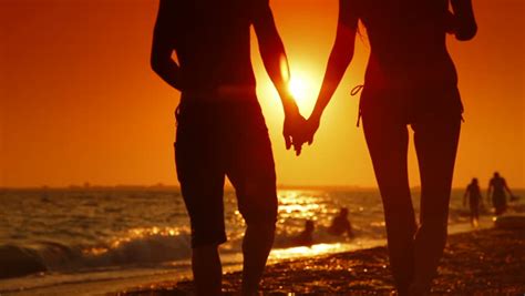 Couple Walking Along Summer Beach At Sunset Stock Footage Video Shutterstock