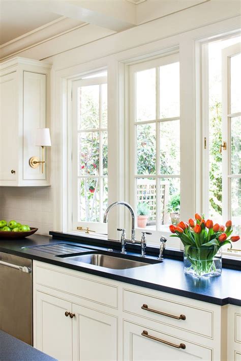 sconces on cabinets above kitchen sink window cottage kitchen sinks kitchen remodel cottage