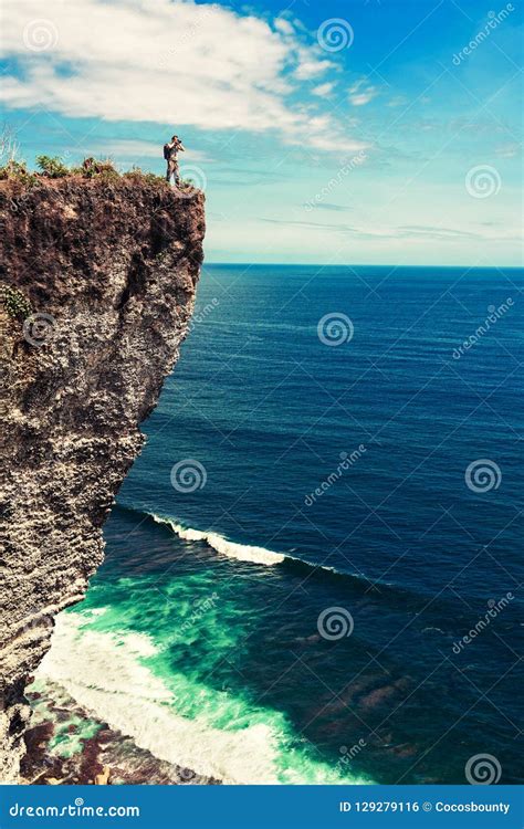 Travel Man Standing On The Top Mountain Cliff On Background Nature