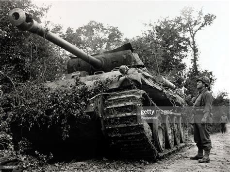 13th July 1944 A Destroyed German Tiger Tank Is Inspected By An