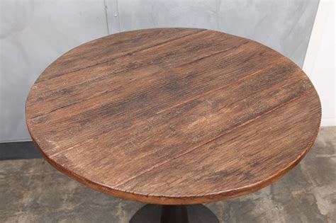 Paintings, an ornate mirror and an antique clock from stockholm line the walls. Antique Metal Base Table For Sale at 1stdibs