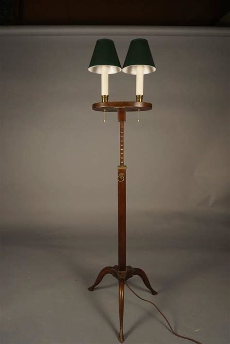 Base is made of wood, which is straight and craved with design and pattern over it. Pair of Colonial Revival Adjustable Floor Lamps at 1stdibs