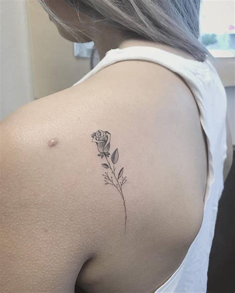 Fine Line Rose Tattoo On The Left Shoulder Blade