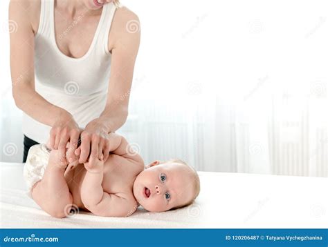 Mother Massaging Her Infant Baby Stock Image Image Of Girl Looking