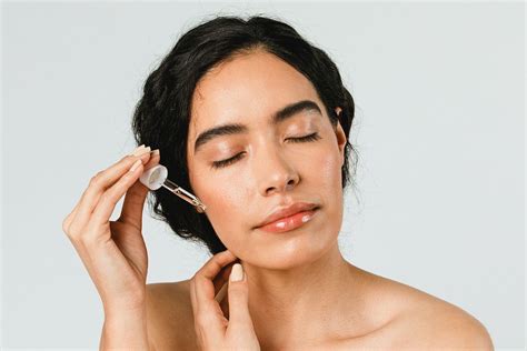 Glowing Skin Woman Applying Serum For A Radiant Complexion