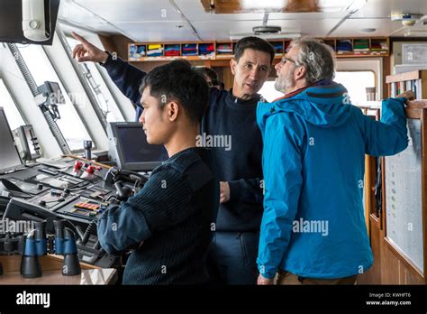 Tourist And Ships Crew On Bridge Sailing Passenger Ship Ocean Adventurer