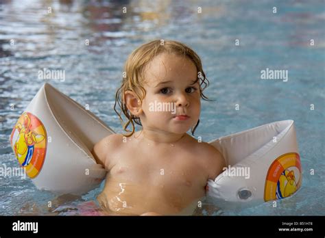 Little Girl With Water Wings In Water Stock Photo Alamy