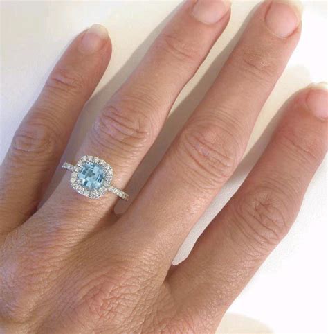 This exquisite engagement ring features a vibrant oval shaped aquamarine weighing 2.07ct set in an open back, four claw setting. Cushion Cut Aquamarine Diamond Engagement Ring in 14k ...