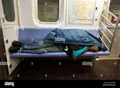 Homeless Man Sleeping On The Subway In New York City Stock Photo Alamy