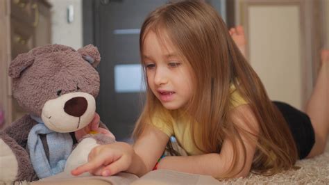 Cute Happy Little Girl With Teddy Bear And Reading Book Pretty Kid At