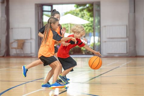 Premium Photo Basketball Kids In Bright Sportswear Playing