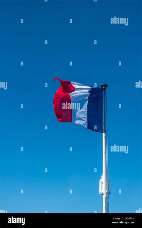 French Flag On The Mast Over A Blue Sky Stock Photo Alamy