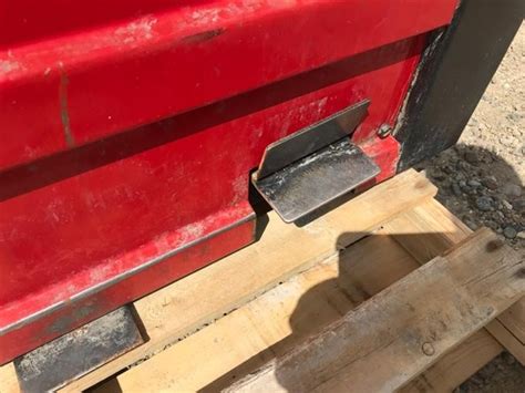 The machine has a red and black exterior with a side where wheel weights are placed with a air compressor within the tire changer. Coats 30-30 Air Operated Tire Changer BigIron Auctions