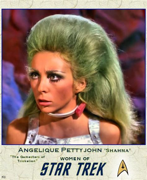A Woman With Green Hair Wearing A Star Trek Uniform In Front Of An
