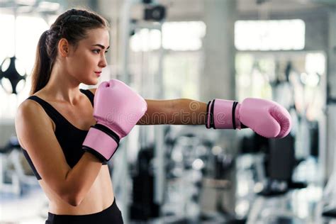 Young Beautiful Woman With Boxing Gloves Exercise In Fitness Gym Stock