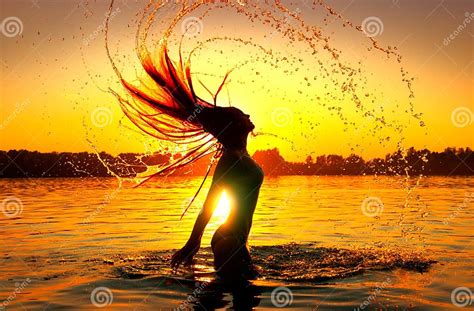 Beauty Model Girl Splashing Water With Her Hair Girl Silhouette Over