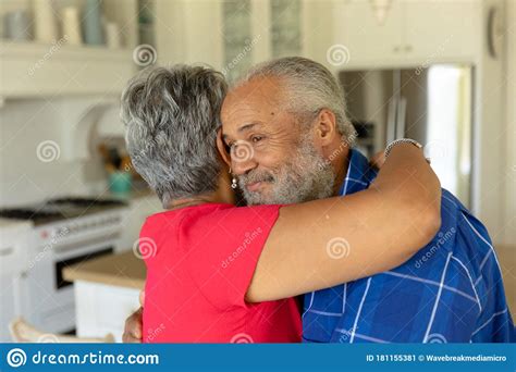 Happy Senior Couple Hugging Each Other In Their Kitchen Stock Image Image Of Race Real 181155381