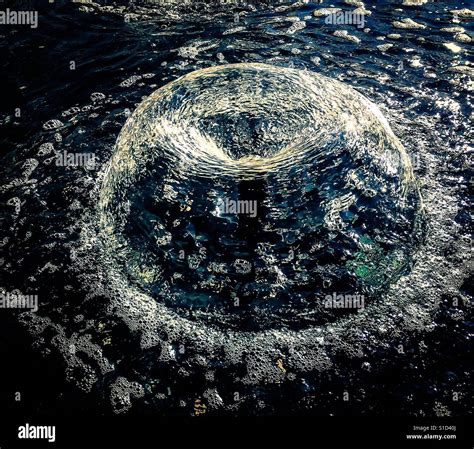 Abstract Round Crystal Fountain With Water Streaming Down Stock Photo