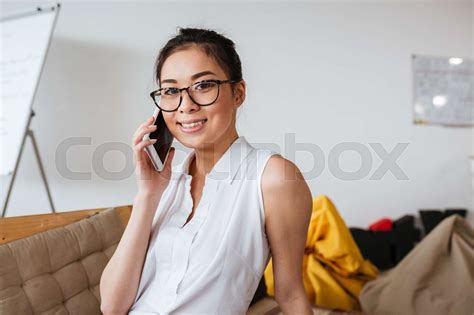 Cheerful Woman In Glasses Talking On Mobile Phone Stock Image Colourbox
