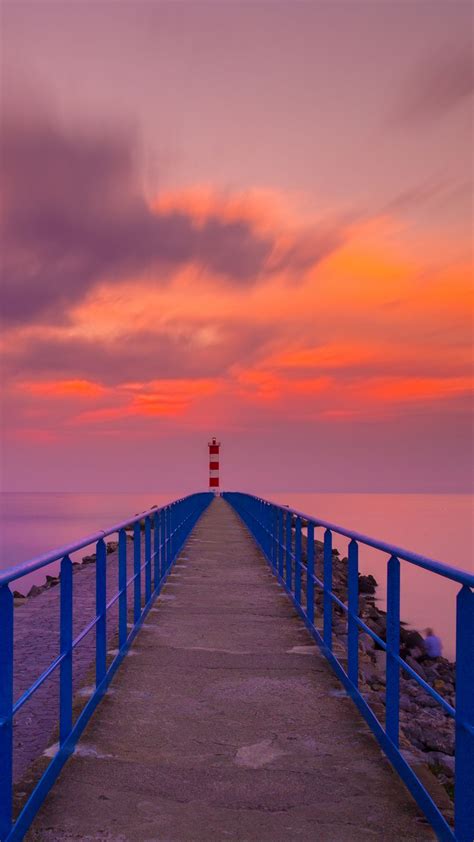 Download Wallpaper 1080x1920 Pier Lighthouse Sea Sunset Skyline