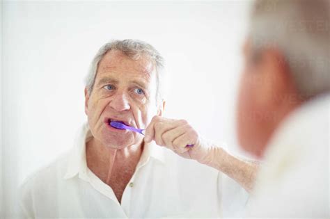 Senior Man Brushing Teeth Stock Photo