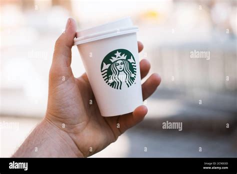 Photo Of Man Hand Holding A Cup Of Coffee Starbucks Brand Stock Photo