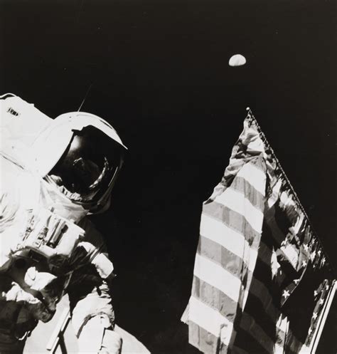Astronaut Harrison Schmitt With The Earth Above The Us Flag December 7