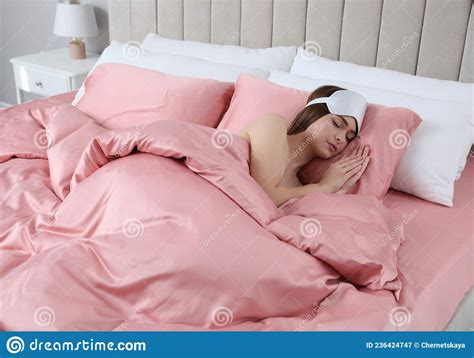 Young Woman Sleeping In Comfortable Bed With Silky Linens Stock Image
