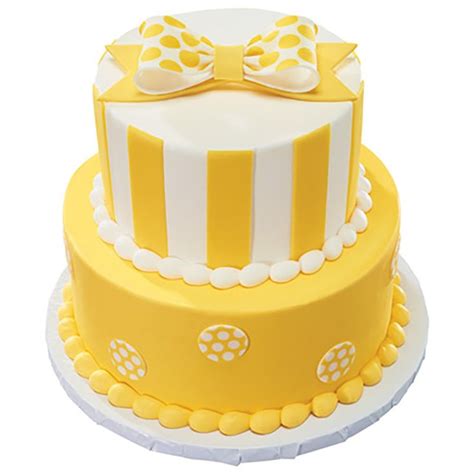 A Yellow And White Cake With A Bow On Top