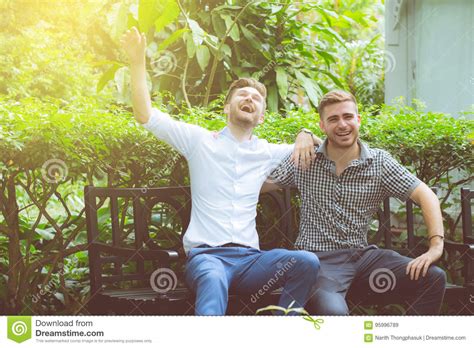 Two Friends Men Talking Standing In A Garden Stock Image Image Of