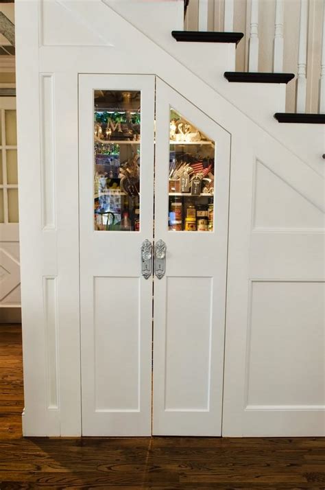 This pantry under the stairs features beadboard, open shelves, and plenty of organization. Slide Out Pantry Storage Under Stairs | Under stairs pantry, Rustic kitchen, Stair storage