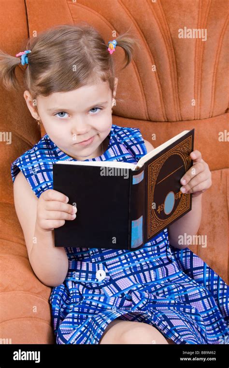 Little Girl Reading Book And Smirk Stock Photo Alamy