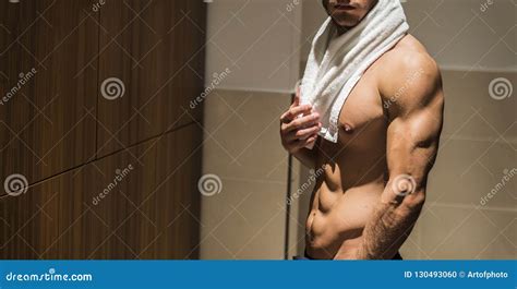 Shirtless Young Male Athlete In Gym Dressing Room With Towel Stock