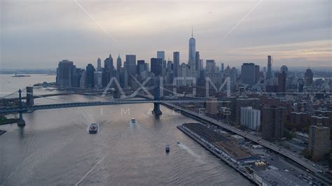 The Manhattan Bridge And The Lower Manhattan Skyline At Sunset In New