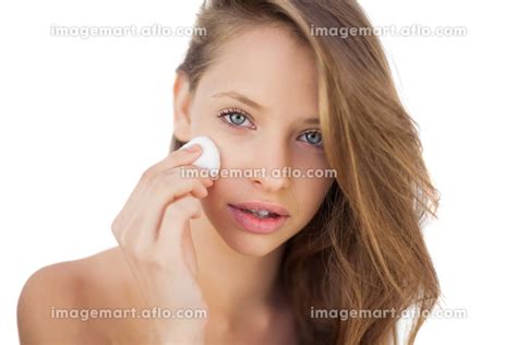 Calm Brunette Model Rubbing Her Face With Cream On White Backgroundの写真