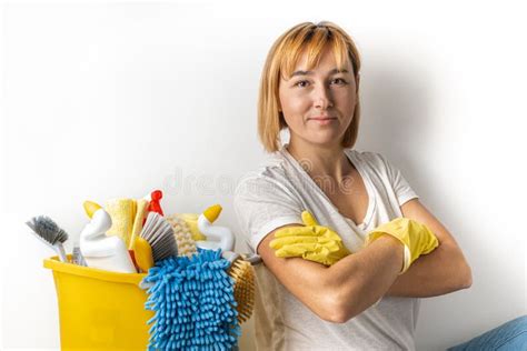 Happy Young Caucasian Woman In Yellow Rubber Gloves Holding Bucket Full