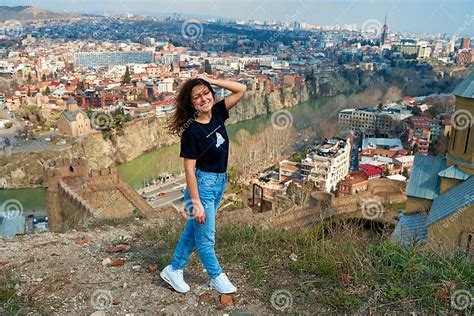 A Cute Brunette Girl Enjoys The Stunning Scenery Of Tbilisi From The