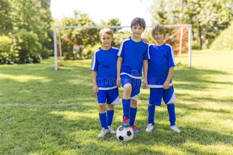 Three Young Boy With Soccer Ball On A Sport Uniform Stock Image