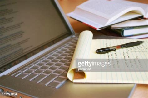 Laptop Computer With Books Pen And Yellow Legal Pad High Res Stock