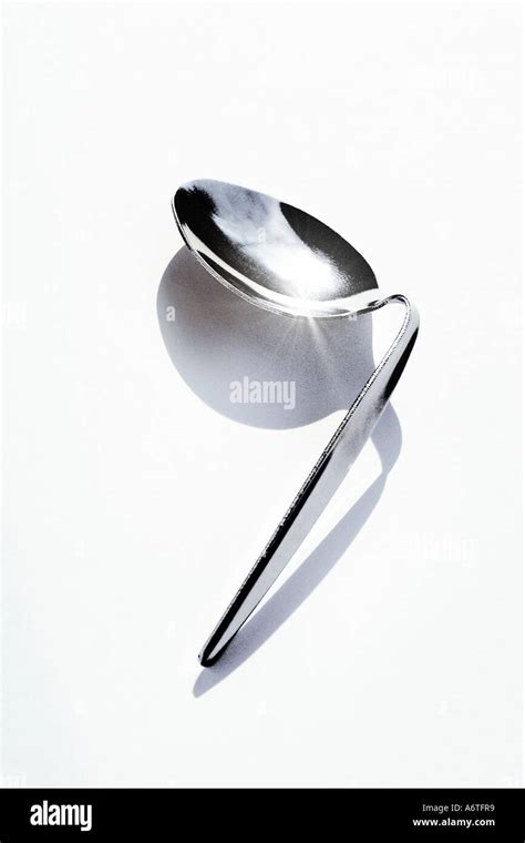 A Bent Shiny Metal Spoon Stock Photo Alamy