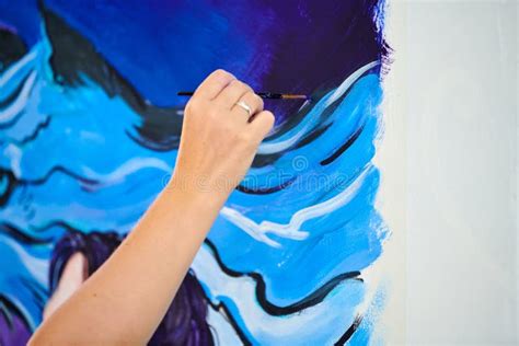 Woman Artist Hand Holds Paint Brush And Draws Surreal Fantasy Image On